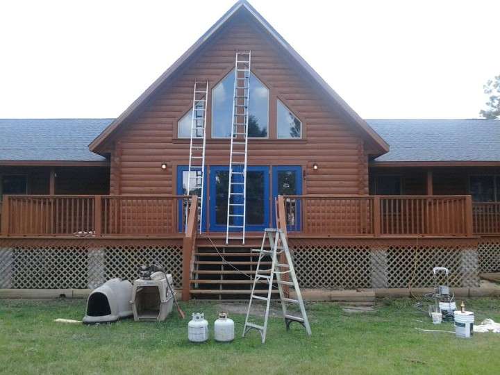 Exterior painting / staining of log cabin home in Eagle Lake FL.